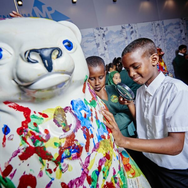 Children painting Little Bears with their hands at the launch